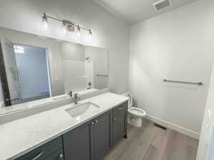 Bathroom with light wood-style floors, vanity, and washtub / shower combination