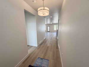 Corridor with light wood-type flooring