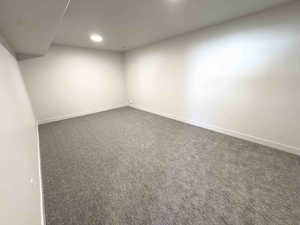 Finished basement with carpet flooring and recessed lighting