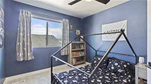 Carpeted bedroom with baseboards and ceiling fan
