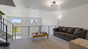 Living area with carpet floors, a chandelier, and recessed lighting
