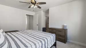 Bedroom with light colored carpet and a ceiling fan