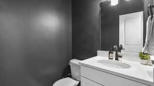 Bathroom featuring vanity and toilet