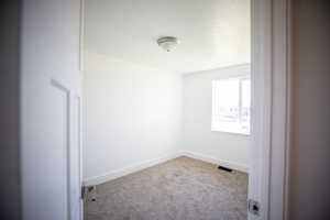 Spare room with carpet floors and a textured ceiling