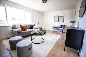 Living room with light wood finished floors and baseboards