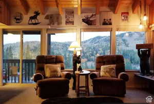 Sunroom featuring beamed ceiling