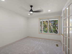 Unfurnished room with light colored carpet, ceiling fan, recessed lighting, and ornamental molding