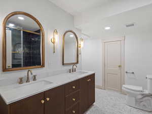 Full bath with 72" double vanity, recessed lighting, and a tile shower