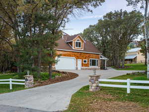View of front facade featuring a fenced front yard and concrete driveway