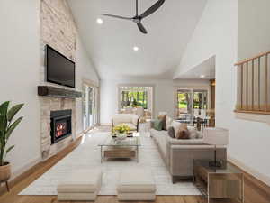 Living room featuring high vaulted ceiling, healthy amount of natural light, recessed lighting, LVP floors, and a NEW fireplace
