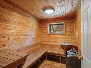 Relaxing sauna / steam room with wooden walls and wooden ceiling.