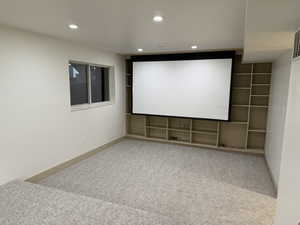 Cinema room with light carpet and recessed lighting