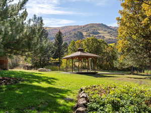 View of home's community featuring a gazebo, a mountain view, and a yard.