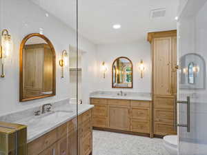 Primary bathroom with a wet-room, freestanding tub, vanity, and a tile shower
