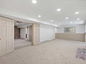Basement with view into theater room with projector & screen.