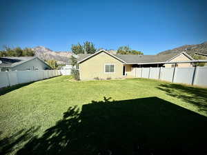 Fenced backyard with a mountain view