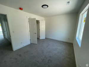 Unfurnished bedroom featuring carpet floors and a textured ceiling