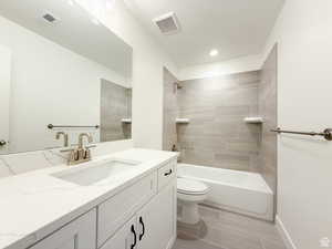Full bath featuring vanity, shower / bathtub combination, and wood finish floors