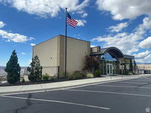 View of building exterior with uncovered parking