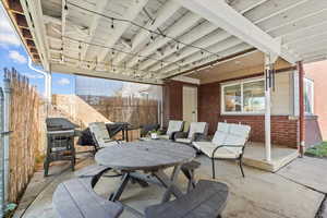 View of patio with area for grilling and outdoor dining space