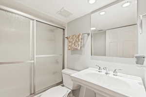 Bathroom featuring enclosed tub / shower combo and recessed lighting