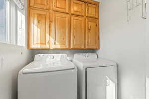 Laundry room featuring washing machine and dryer and cabinet space