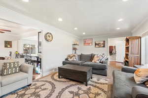 Living area featuring crown molding, recessed lighting, wood finished floors, plenty of natural light, and a ceiling fan