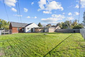 Fenced backyard with a gate and a patio