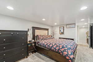 Bedroom featuring light colored carpet and recessed lighting