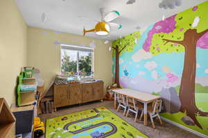 Rec room with carpet floors and baseboards