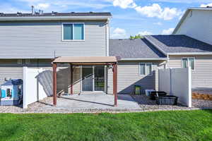 Rear view of property with a shingled roof, a gazebo, and a patio