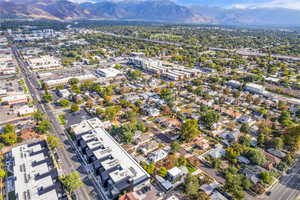 Aerial view of property and surrounding area with mountains and nearby urban area