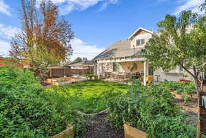 Fenced backyard featuring a patio area and a garden