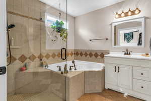 Bathroom featuring a shower stall, vanity, a bath, and light tile patterned floors