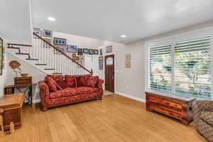 Living area with stairway, light wood-type flooring, and recessed lighting