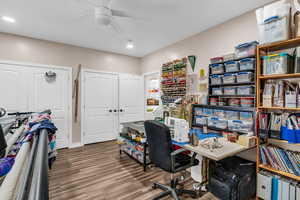 Office featuring wood finished floors, ceiling fan, and recessed lighting