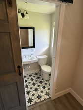 Bathroom with baseboards and light wood finished floors