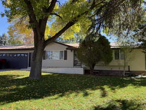 View of side of home with a yard and a metal roof