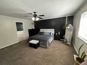 Bedroom with ornamental molding, carpet flooring, ensuite bathroom, ceiling fan, and a textured ceiling