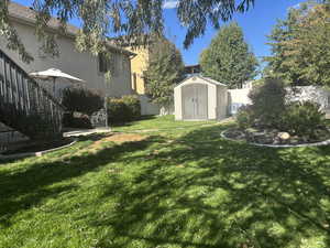 Fenced backyard with a storage shed