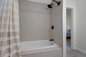 Full bathroom featuring tiled shower / bath and ensuite bath