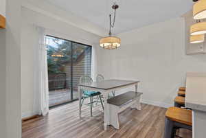 Dining area with baseboards and light wood-style floors