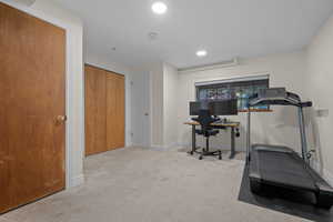 Exercise room featuring light colored carpet and recessed lighting