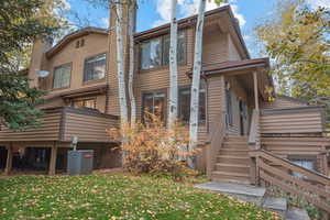 Rear view of house with a yard and a chimney