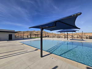 Community pool featuring a patio and a mountain view
