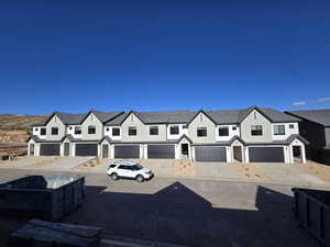 View of front facade featuring concrete driveway and an attached garage