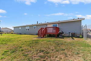 Back of house featuring a deck and crawl space