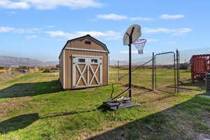 View of shed featuring a gate and a mountain view