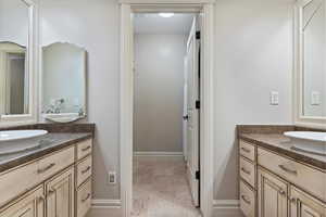 Bathroom with two vanities and baseboards