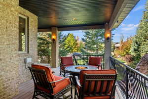Wooden deck featuring an outdoor fire pit
